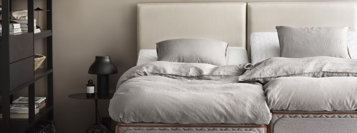 Bedroom interior with the DUX adjustable bed Axion and Flex headboard, showing the adjustable feature